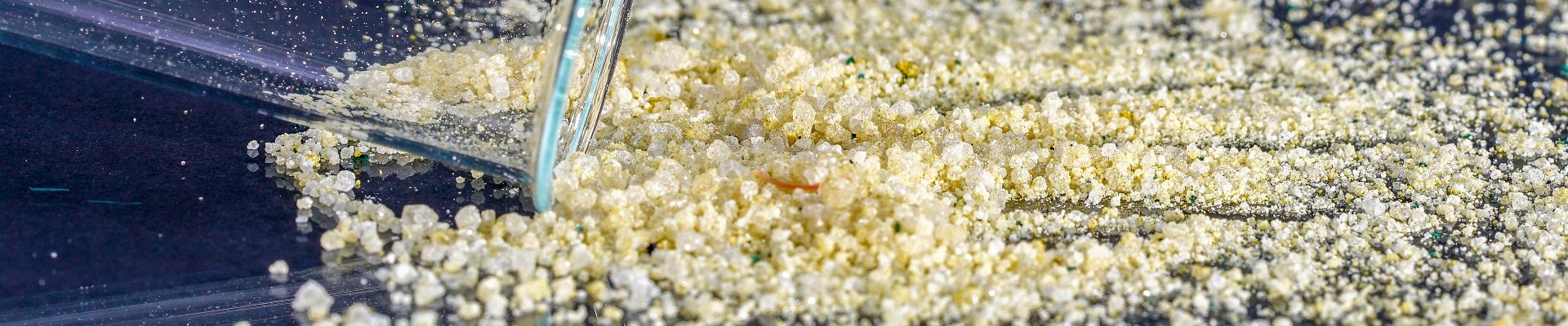 A closeup of an ammonium iron sulfate on a glass surface in the studio